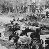 photo of the construction of the Civic Auditorium  building in 1932, with construction works excavating with ground, pick-up trucks filled with dirt, and work horses